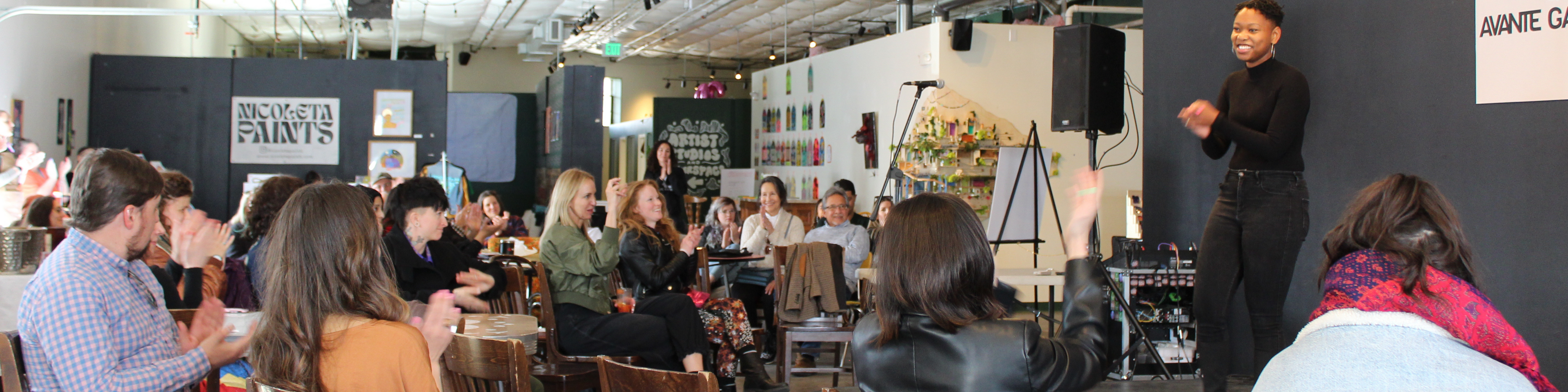 Group of people gathered at a local performance venue